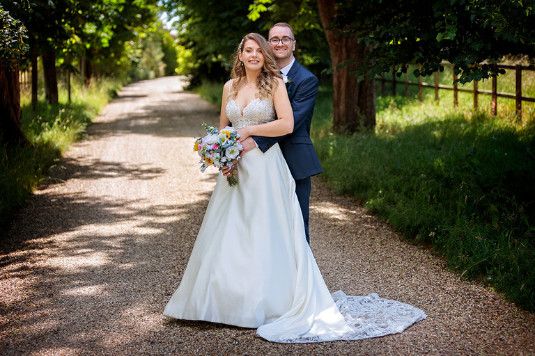Bride and Groom on a countryside path at The Wellington Arms