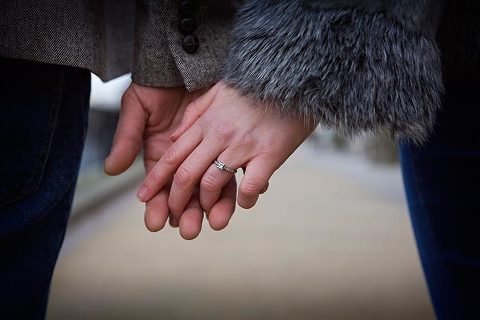 engaged couple in London holding hands