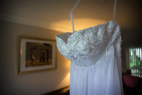 brides dress hanging before kent wedding