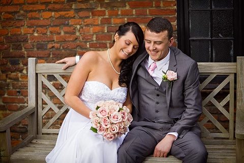 newlyweds sitting on a bench