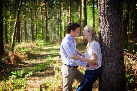 engaged couple by tree in New Forest