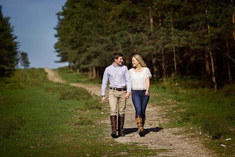 walking couple on their engagement photos shoot in the New Forest