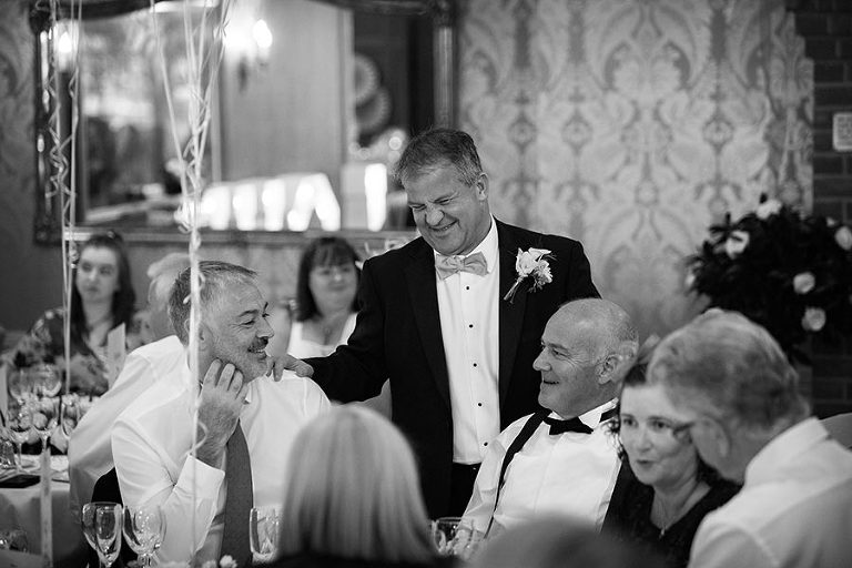 groom and guests by Tylney Hall wedding photographer