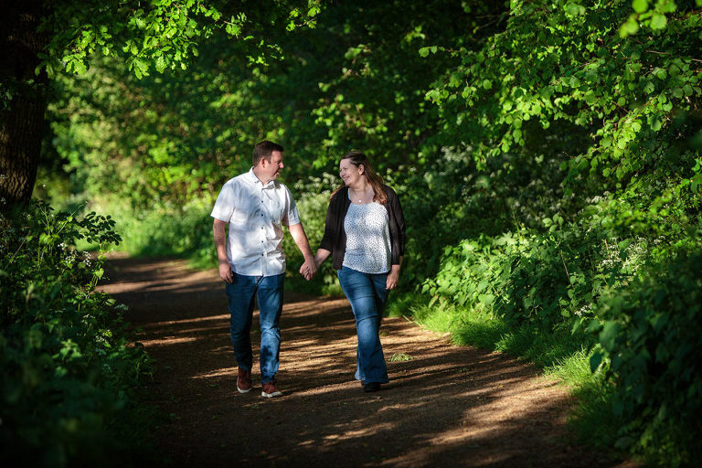 Basingstoke photographer pre-wedding photo couple walking in woods