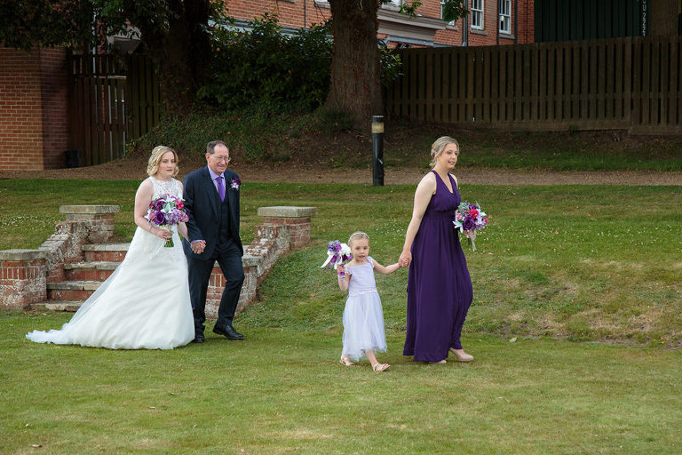 bride walking with father and bridesmaids at highfield park wedding