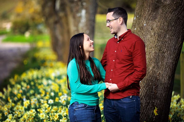 pre-wedding photo of couple with daffodils at dummer down farm