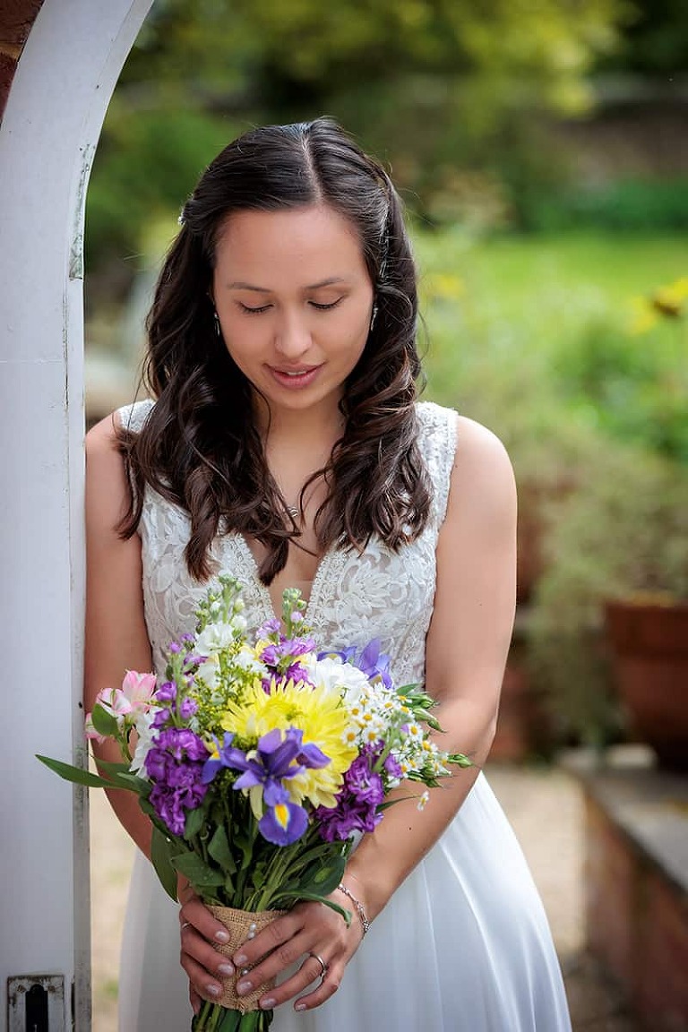 bride with flowers at dummer down farm wedding