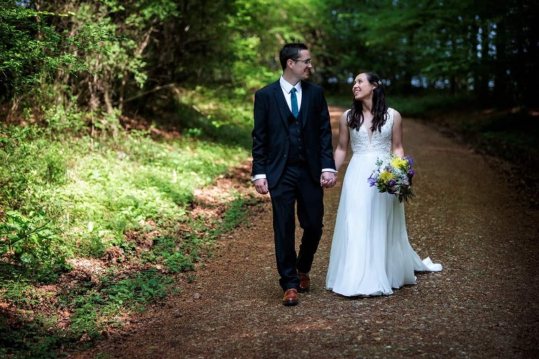 bride and groom walking by hampshire wedding photographer