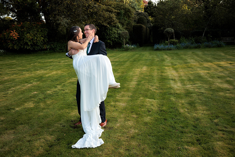 bride and groom in garden by hampshire wedding photographer
