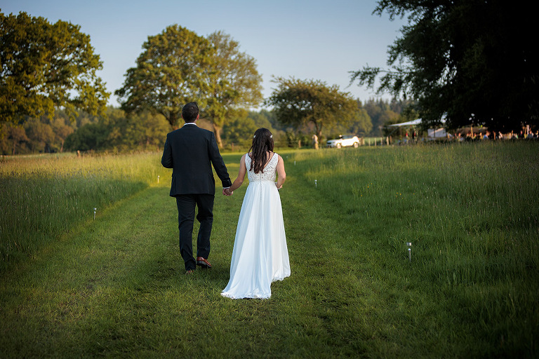 bride and groom at dummer down farm by hampshire wedding photographer