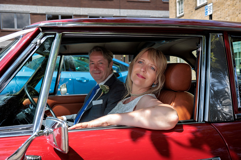 happy couple in car by Basingstoke registry office wedding photographer