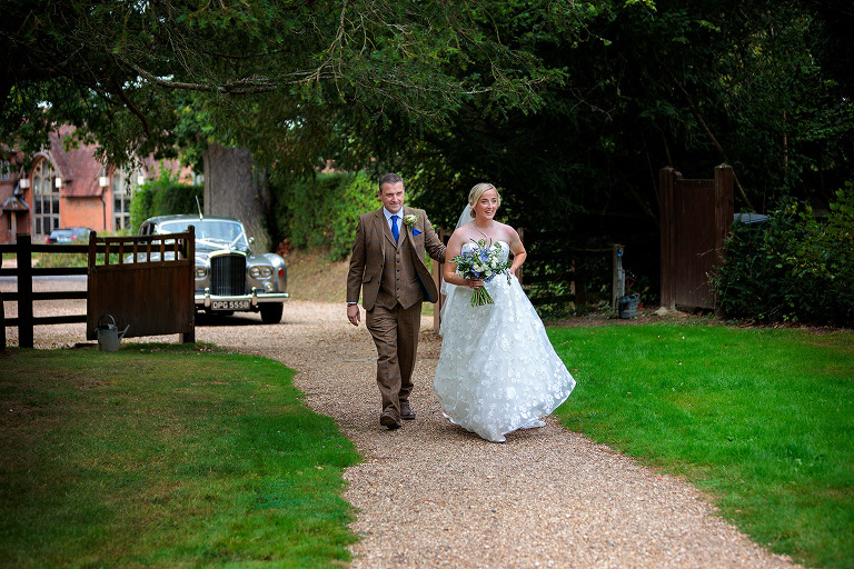 Bride arrives for wedding at st mary's church winchfield
